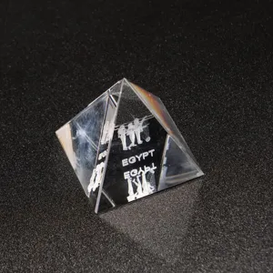 Clear crystal pyramid detail showing 3D laser engraved Egypt figures and text inside.