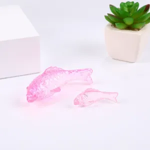 Pink crystal fish figurine detail, translucent glass ornament for home decor and tabletop display.