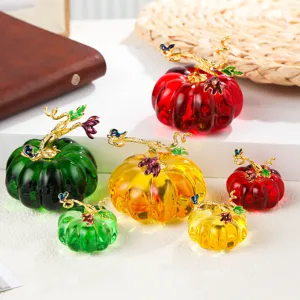 Detailed view of colorful crystal glazed pumpkin craft ornaments with gold metal vines.