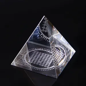 Clear crystal pyramid ornament with 3D laser engraved Feng Shui Bagua symbols for home decor.