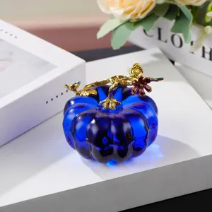 Blue crystal pumpkin ornament detail, gold branch top, elegant desktop decor display.