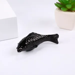 Detailed closeup of elegant black crystal fish figurine, ideal for home decor display.
