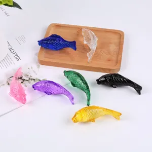 Detailed view of colorful glass fish figurines, crystal ornament, vibrant home decor display.