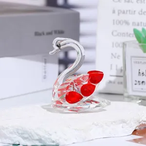 Crystal swan figurine detail view featuring sparkling red crystal elements on white textured base