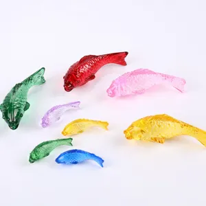 Colorful translucent glass fish figurines detail view showing exquisite craftsmanship and varied sizes.