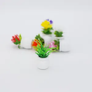 Miniature potted plant dollhouse accessory, detailed green grass in tiny white ceramic pot.