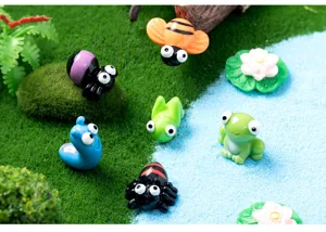 Close-up detail of resin animal miniatures for moss landscape DIY garden decor and crafts.