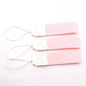 Close-up detail of pink portable cup handle straps with white elastic loops and PU leather patch.