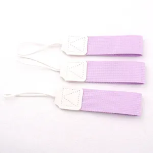 Detailed close-up view of portable purple cup straps with white leather connectors for bottles.