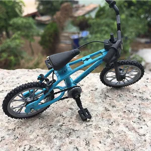 Mini finger bicycle toy detail shot, alloy BMX model with blue frame and black parts.