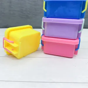 Miniature dollhouse storage box detail shot, colorful plastic container with lid and clasp.