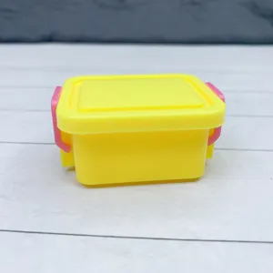 Miniature plastic storage box detail, cute yellow container with pink latches, dollhouse prop.
