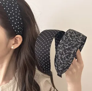 Detailed view of Korean style wide black and white headband with cute floral patterns.