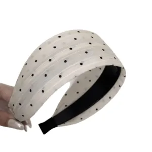 Chic wide black and white polka dot headband for women, stylish high crown hair hoop accessory.