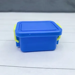 Miniature plastic storage box detail, cute blue container with yellow clasps for dollhouse decor.
