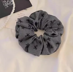 Grey bowknot scrunchie hair tie, elegant fabric hair accessory for women and daily use.