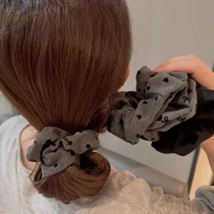 Chic grey polka dot hair scrunchie, elegant bow design for daily wear and lovely buns.