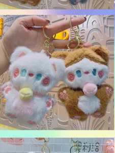 Detailed close-up of cute plush cat bear keychain featuring soft fabric and sweet blush design.