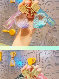 Close-up detail of liquid whale keychain, showing vibrant glitter inside transparent pendant.