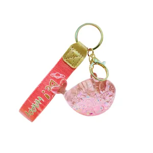 Cute liquid floating whale keychain with pink strap sparkling glitter charm cute accessory.