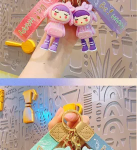 Cute cartoon electroplated transforming girl keychain pendant with ribbon strap and metal ring.