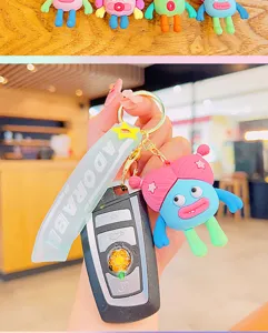 Cute quirky girl keychain pendant, adorable silicone cartoon doll bag ornament accessory.