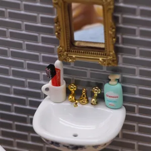 Miniature dollhouse bathroom sink vanity setup with mirror, tiny toothbrush and shampoo.