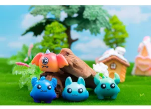 Close-up detail shot of cute mini resin monster figurines in micro landscape desktop decor.