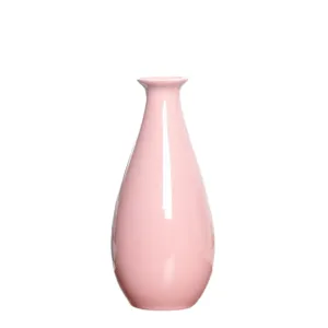 Minimalist pink ceramic mini vase for hydroponic plants and modern home office decor.