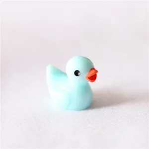 Detail view of cute mini resin duck figurine, candy blue color, ideal for micro landscape decor.