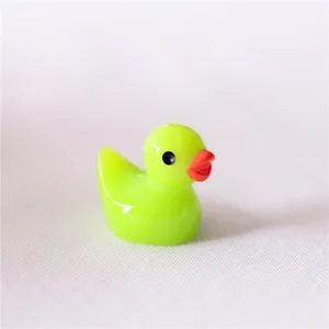 Close-up detail of cute neon green resin duck miniature ornament, perfect for DIY phone case decor.