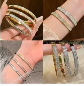 Detailed view of luxury titanium steel rhinestone pave bangle bracelet, sparkling elegant design.