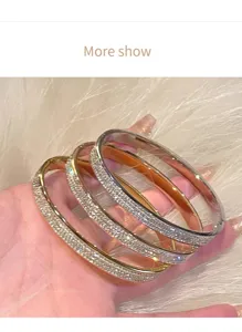 Detail view of sparkling rhinestone titanium steel bangles, versatile starry design for women.