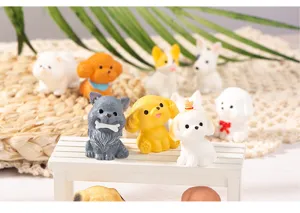 Close-up detail of cute miniature resin puppy figurines arranged on a tiny white bench for desktop decor.