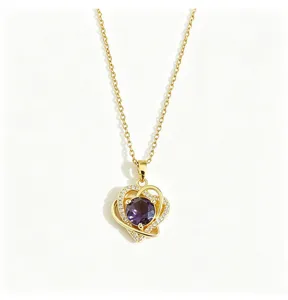 Detail shot of the gold-plated titanium steel necklace featuring a purple zircon and pavé hearts.