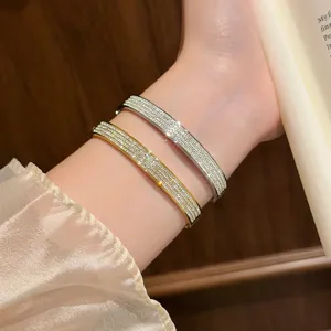Korean style titanium steel crystal pave bangles worn on wrist, main product display photo.