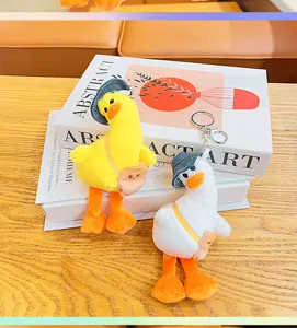 Cute plush crooked-head duck keychain, soft mini backpack pendant toy with hat and bag.