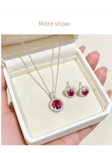 Close-up detail of the elegant round red zircon necklace and matching earrings set display.