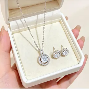 Exquisite silver tone circular cubic zirconia pendant necklace and matching stud earrings set.