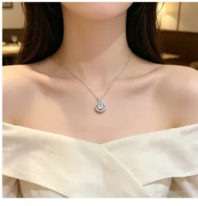 Elegant round zirconia pendant necklace with sparkling stones on a delicate clavicle chain.