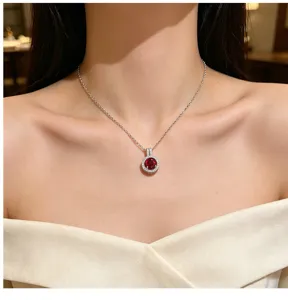 Close-up detail shot of exquisite silver clavicle chain necklace with a dazzling red zircon.
