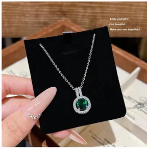 Close-up detail of the elegant round green gemstone necklace with sparkling crystal halo.