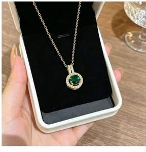Exquisite green zircon pendant necklace close-up, shiny halo diamond design gold chain.