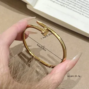 Titanium steel nail shape bracelet with four-leaf clover design, fashion gold bangle for women.