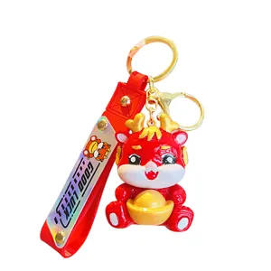 Red cartoon dragon keychain with gold ingot pendant, cute zodiac mascot gift for New Year.