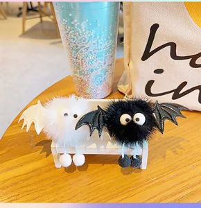Plush little devil keychain pendant, cute bat wings design with hanging legs, detailed view.
