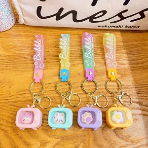Cute mini glowing TV keychain set with silicone strap, colorful cartoon bag pendant charms.