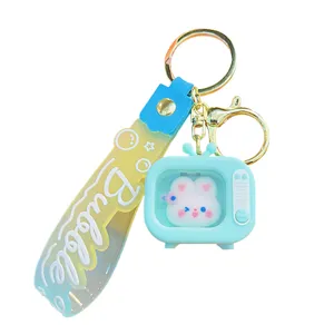 Cute luminous mini TV keychain with lovely rabbit doll pendant, creative bag ornament accessory.