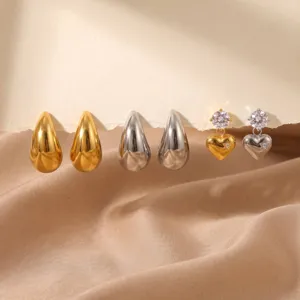 Detailed view of trendy stainless steel earrings set featuring gold and silver teardrop designs.