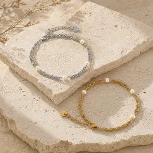 Exquisite stacked pearl bracelets in gold and silver tones featuring intricate woven chain designs.